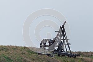 Wooden Medieval Catapult Ballistic Device. Ancient Military Technology