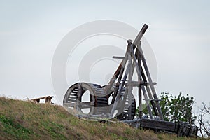 Wooden Medieval Catapult Ballistic Device. Ancient Military Technology