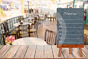 Wooden menu display sign, Frame restaurant message board on wooden table, Blurred image background.