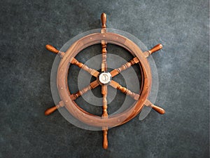 Wooden metal old steering wheel on a dark background.