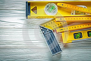Wooden meter construction level try square on white board
