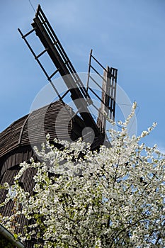 Wooden Mill on blue sky background. Old Windmill at dawn. Windmill farm. Rural landscape village on the hill in Trzew