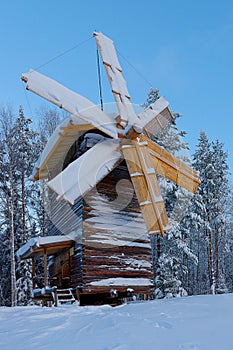 Wooden mill covered with snow, tourist complex Malye Karely, Arkhangelsk region, Russia