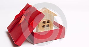 Wooden miniature house in a gift box. Housing as a gift. Win an apartment in the lottery. To inherit property. Holiday discounts.