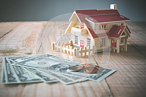 wooden model house with money on wood table with copy space read