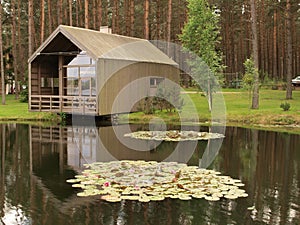 Wooden modern house at a pond