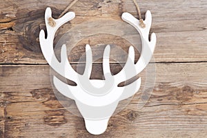 Wooden moose head on wooden background