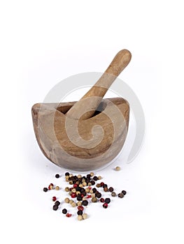 Wooden mortar and pestle with peppercorn