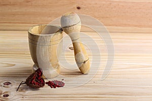 Wooden mortar to grind and Annatto tree Bixa orellana L.
