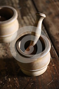 Wooden mortars and pestle on brown plank table