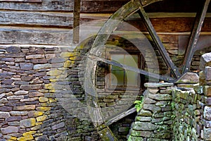 Wooden moss covered water wheel on an old grist mill