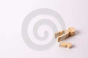 Wooden mother figures with a hollow inside in the shape of a child and a child`s figurine lie on a white background.