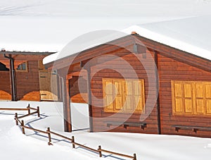 Wooden mountain chalet in the Alps in Italy after a snowfall photo