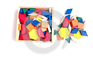 Wooden multi-colored blocks in a wooden box on a white background