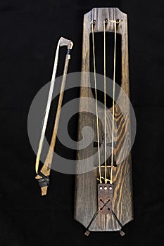 Wooden musical bowed harp instrument of talharpa
