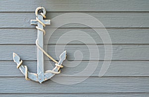 Wooden nautical anchor on wood wall