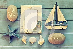 Wooden nautical frame and sailing boat on wooden table. nautical lifestyle concept. vintage filtered. template