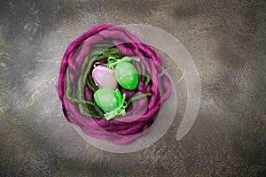 Wooden nest with Easter eggs on dark background