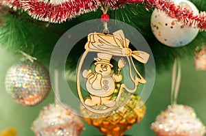Wooden new year christmas toy on a fir tree