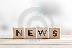 Wooden news sign on a table