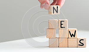 Wooden news sign on a table in an office