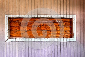 Wooden niche in a weathered old wooden wall