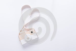 Wooden nordic camera toy for babies on white background, top view