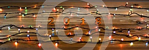 Wooden numbers forming the number 2018 and Christmas lights on a