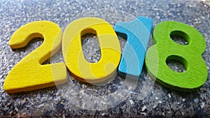 Wooden numbers forming the number 2018, For the new year 2018 on a abstract background