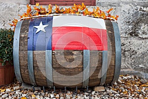 Wooden oak barrel with Texas flag painted on/ Decorative oak barrel in front of winery