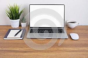 Wooden office desk table with keyboard of laptop, coffee cup and notebook, mouse computer