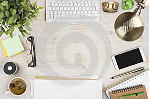 Wooden office desk top view with stationery and computer accessories