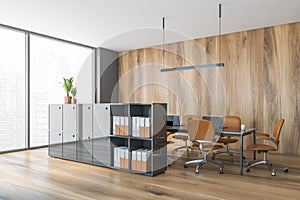 Wooden office room with shelf for folders and brown furniture