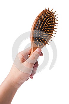 Wooden old comb in hand on blackground