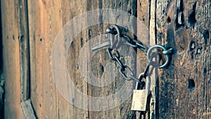 Wooden old house door and padlock on