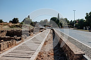 Wooden old road for pedestrians next to the ancient paving stones of the ancient city of Side Turkey. Travel to the sights of the