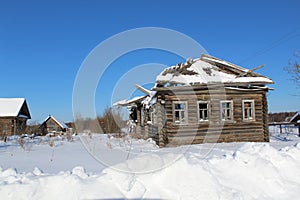Wooden old ruined house in the village.