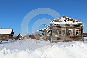 Wooden old ruined house in the village.