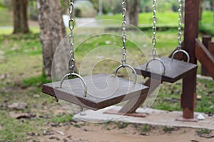 Wooden old swings in park