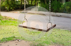 Wooden old swings in park