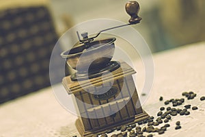 Wooden old vintage manual coffee grinder and coffee beans