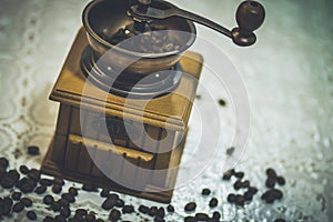 Wooden old vintage manual coffee grinder and coffee beans