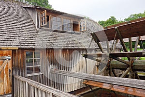 Wooden old water mill in Germany . Wooden water wheel next to building . Mill museum next to Bielefeld . Old historic flour