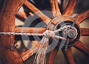 A wooden old wheel from a cart that was used for harvesting in the village. Transport of the past. Agriculture and the peasantry