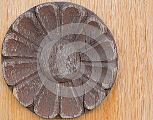 Wooden ornament resembling a sun or blossom