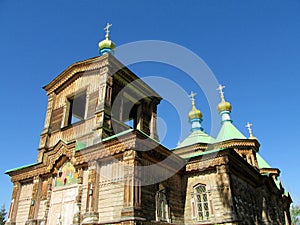 Wooden orthodox church with golden cross on the roof