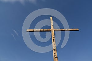 Wooden Orthodox cross against the sky (translation: save and preserve
