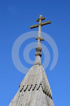 Wooden Orthodox cross on a blue sky background.