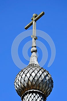 Wooden Orthodox cross on a blue sky background.