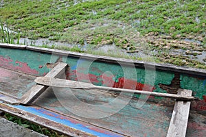 Wooden paddle in old row boat